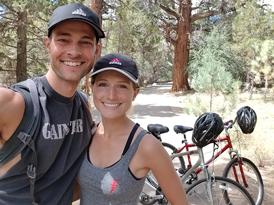 Matt Vande Vegte and his wife standing in front of two bikes.