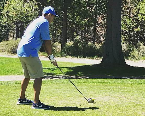 Golfer prepares to take next swing.